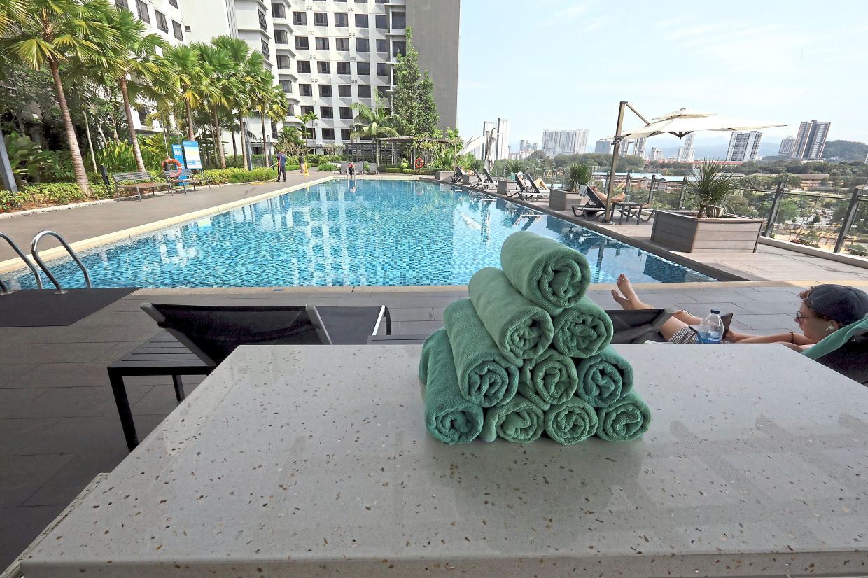 Facilities such as swimming pools (above), game rooms and gym ensure residents stay active. — AZLINA ABDULLAH/The Star