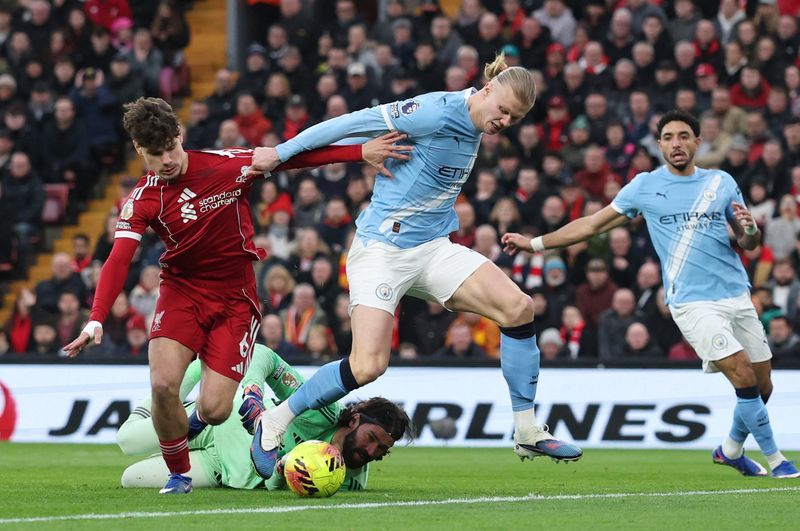 Soccer-Man City snatch chaotic 2-1 win at Liverpool to stay on Arsenal's heels
