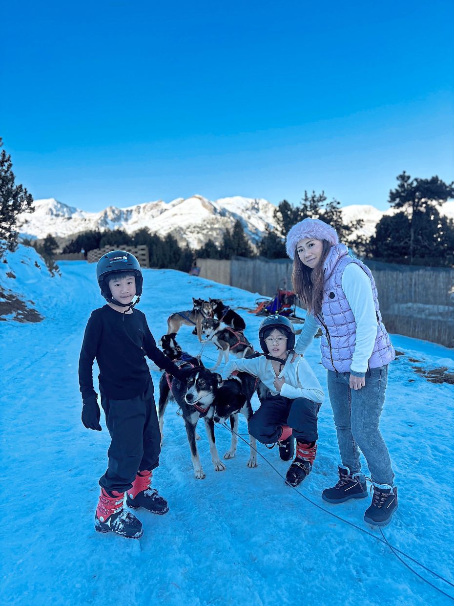 The writer (right) and her two boys making fast friends with the dogs. — Photos: LOUISA LIM