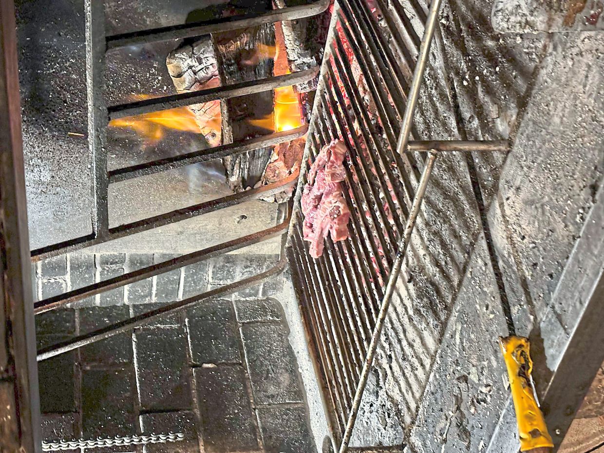 Cuts of meat grilled over an open flame at Borda L’Era del Rossell, a rustic restaurant serving Pyrenean fare.