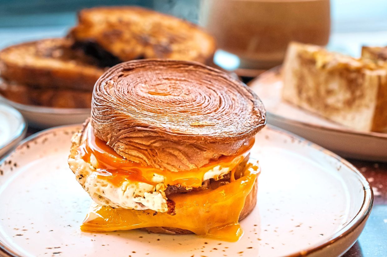 The croissant-burger hybrid model features flaky pastry, homemade chicken patty and a locally-influenced sauce to tie it all together. — MPB 