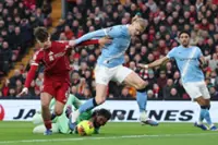 Soccer-Man City snatch chaotic 2-1 win at Liverpool to stay on Arsenal's heels