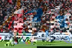 Soccer-Man City snatch chaotic 2-1 win at Liverpool to stay on Arsenal's heels