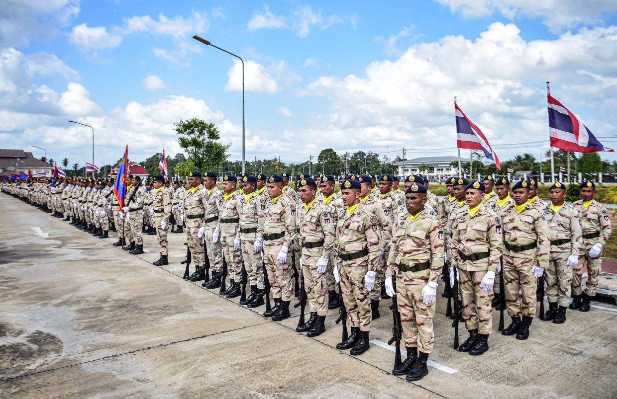 Thai civilian defence volunteers take part in a parade on the eve of the annual Defence Volunteers Day in Narathiwat, southern Thailand. -- Photo by Madaree TOHLALA / AFP