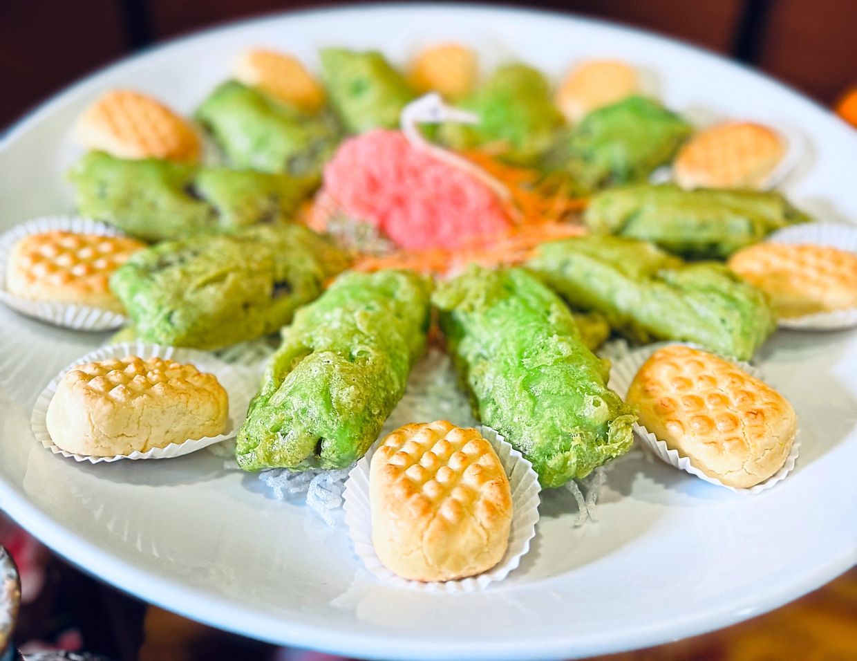 Pineapple tarts and fried ‘nian gao’ are a festive delight.
