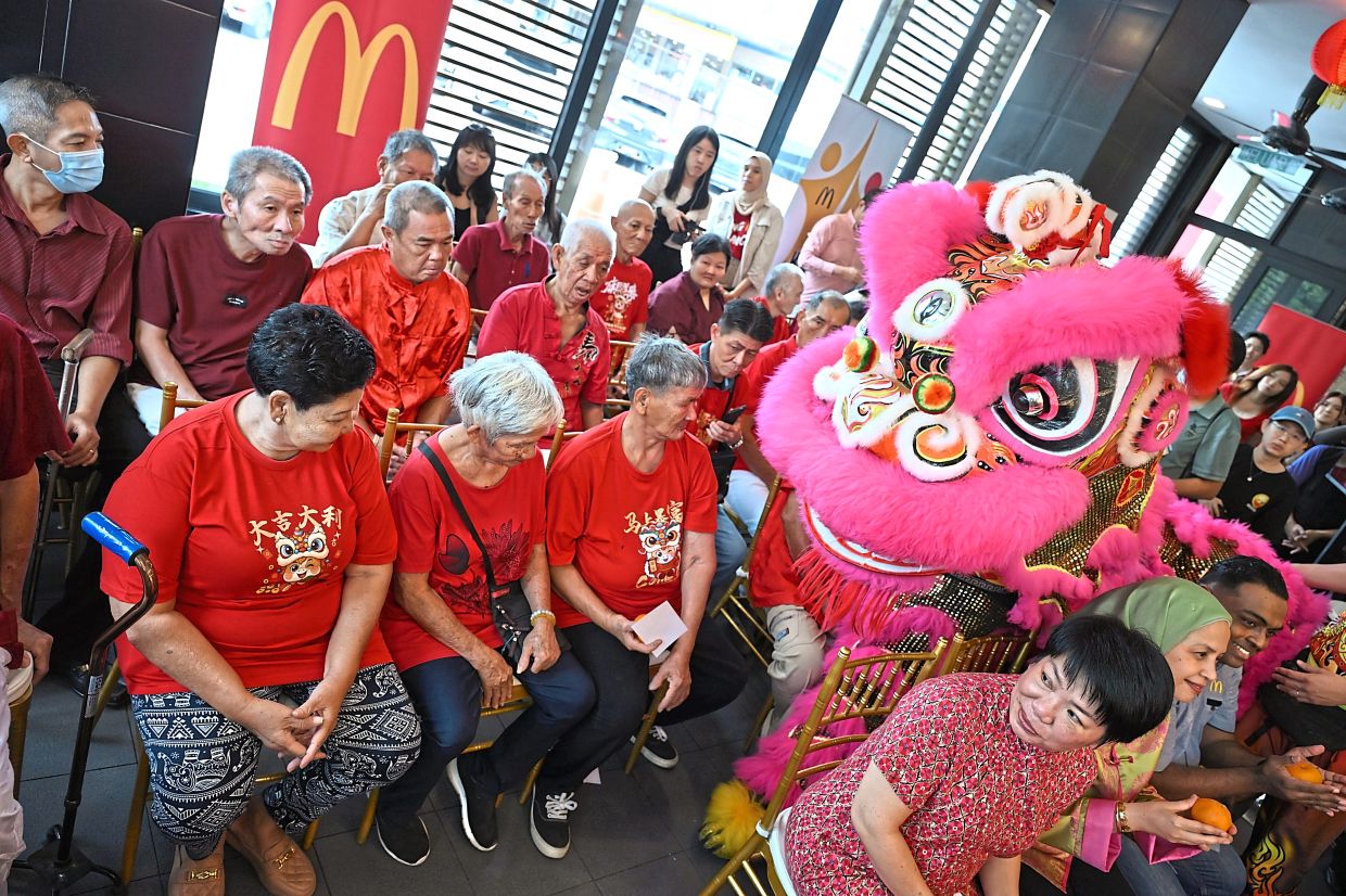 The old folks being treated to a lion dance, cultural performances and hearty McDonald’s meals.