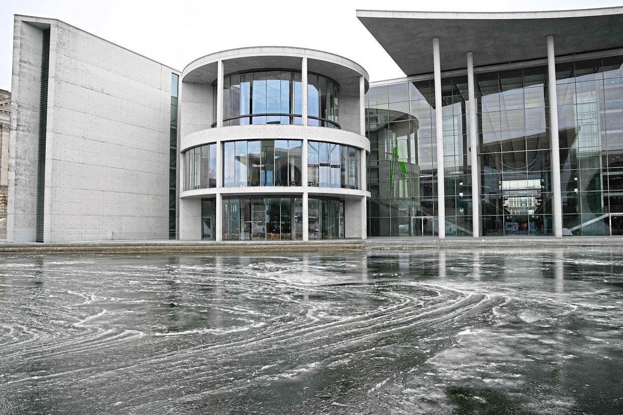 View of the partly-frozen river Spree in front of the parliamentary building, Paul-Loebe-Haus, in Berlin, as the German capital experiences icy weather conditions. — AFP