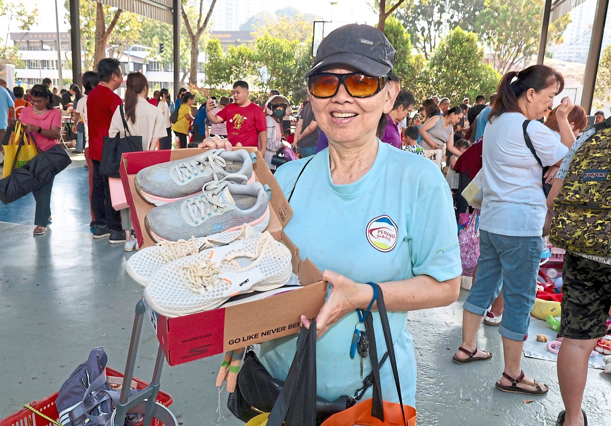 Tan showing the shoes she got at the free market.