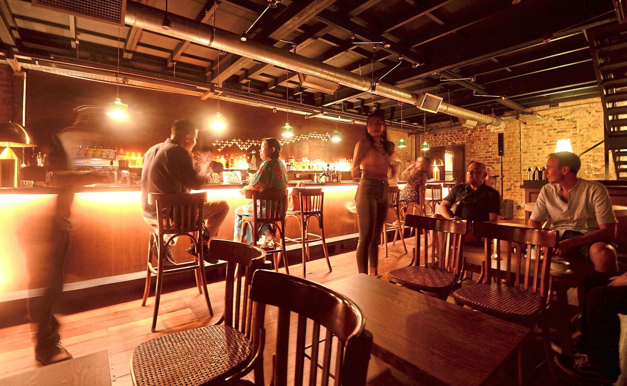 Jao Tim in Jalan Sultan, Kuala Lumpur is bathed in a golden glow of dark wood and brass. — Filepic