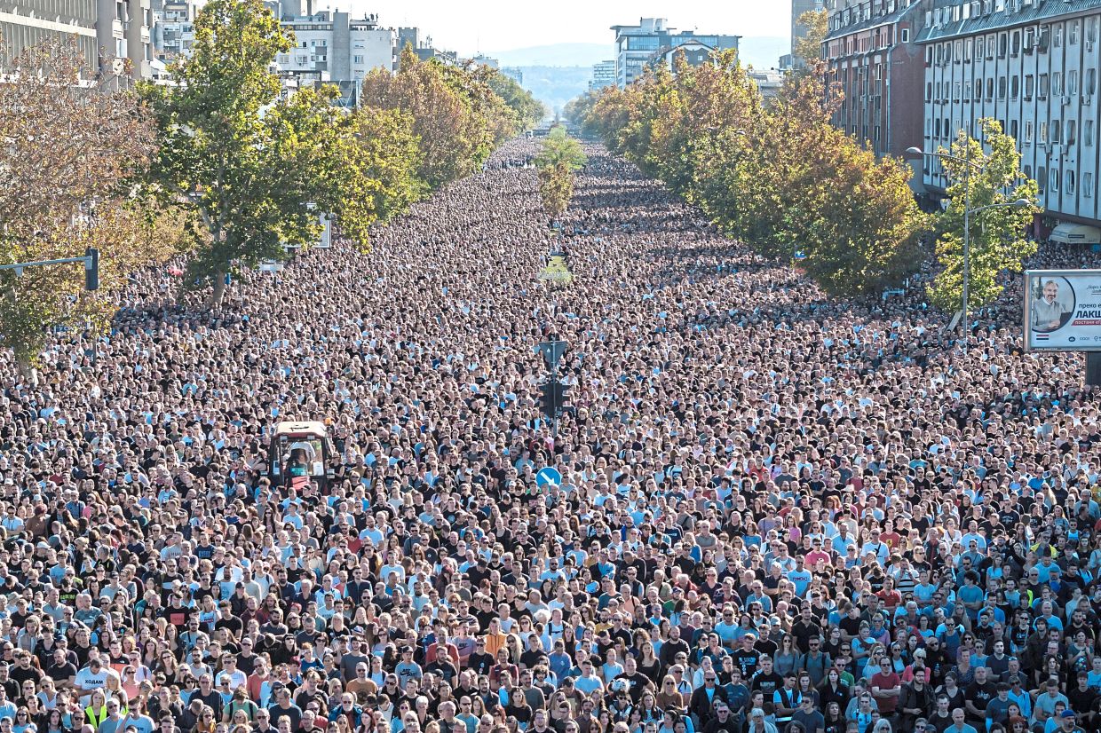 People observing 16 minutes of silence outside the Novi Sad railway station on the first anniversary of the November 2024 canopy collapse which killed 16 people. — Reuters