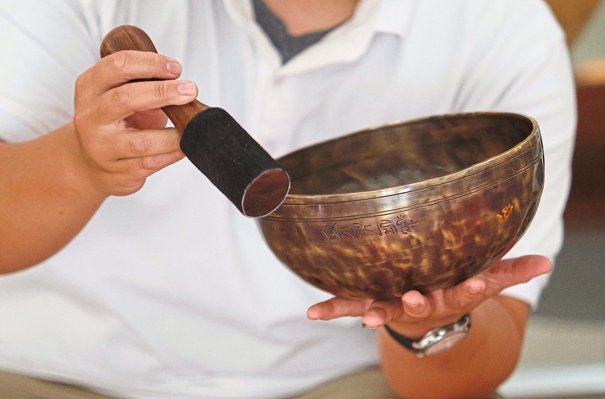 Singing bowls, including traditional metal Tibetan bowls like this one, are instruments that produce sustained, harmonic sounds and vibrations when struck or rubbed with a mallet.