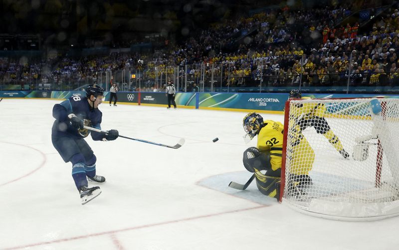 Olympics-Ice hockey-Finland muscle past Sweden, Slovakia beat hosts Italy