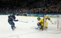 Olympics-Ice hockey-Finland muscle past Sweden, Slovakia beat hosts Italy, Czechs notch win