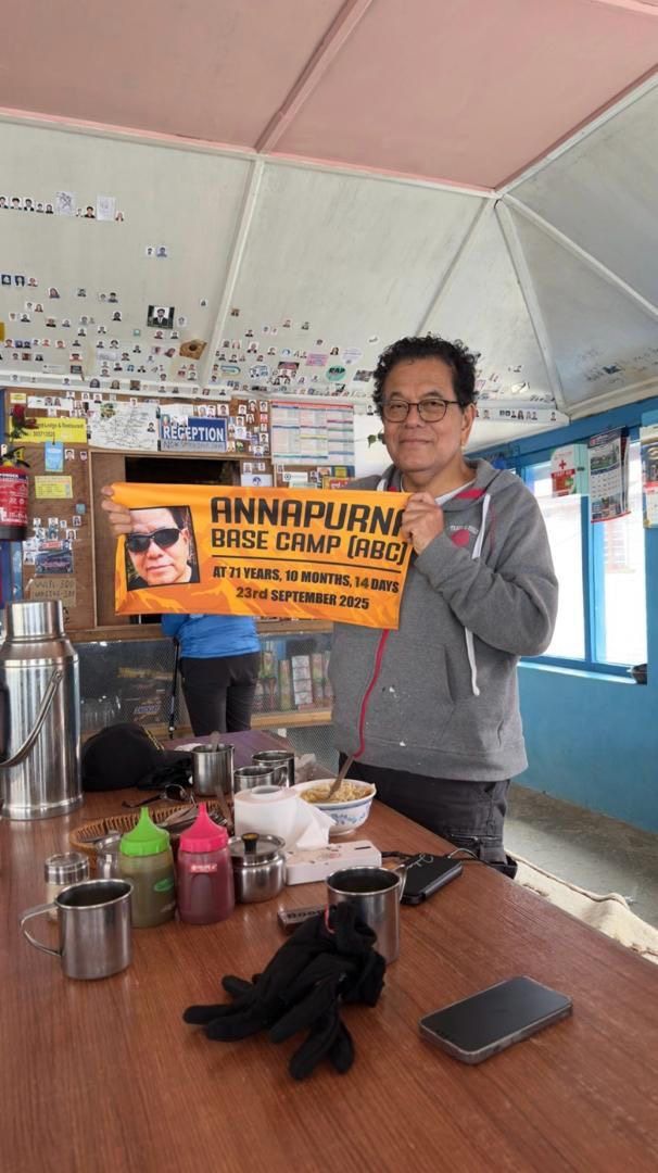 The writer proudly showing off his little banner that he had made prior to his trek.