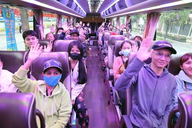 Workers and their relatives return to their hometowns in the central and northern provinces to celebrate Tet (Lunar New Year) under the “Trade Union Bus Trip – Spring ” programme on Feb 12. - Photo: VNA/VNS