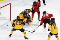 Olympics-Ice hockey-Canada into semis, with Poulin back from injury and equalling scoring record