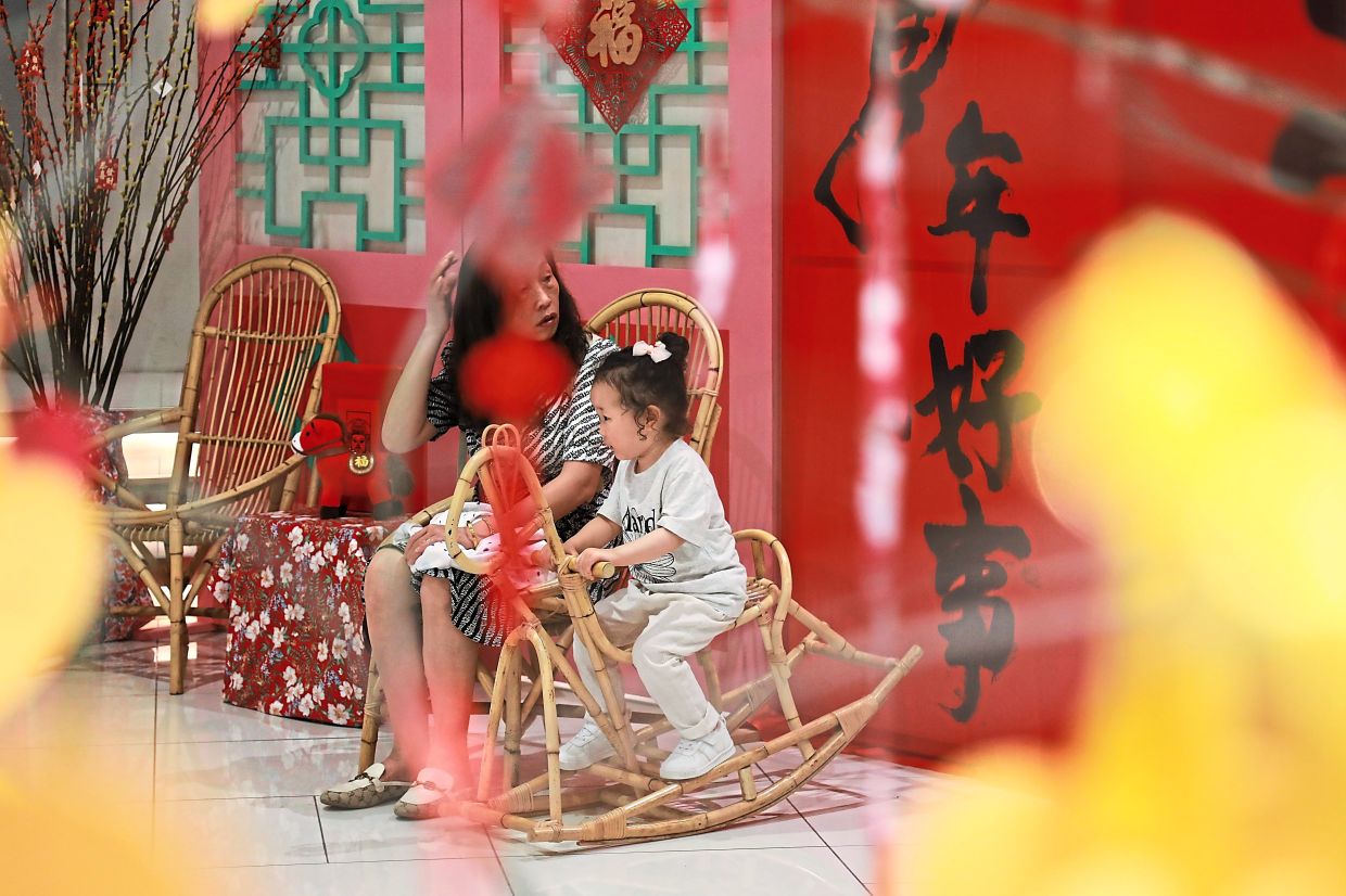 A child sitting on a horse-shaped rocker at the ‘Horse-Seh-Liao’ bazaar.