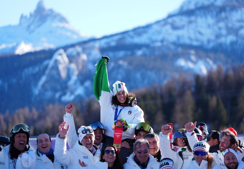 Olympics-Italy sets Winter Games record on medal‑heavy Sunday