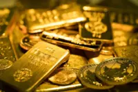 Gold slips to one-week low as safe-haven buying stalls, dollar strengthens