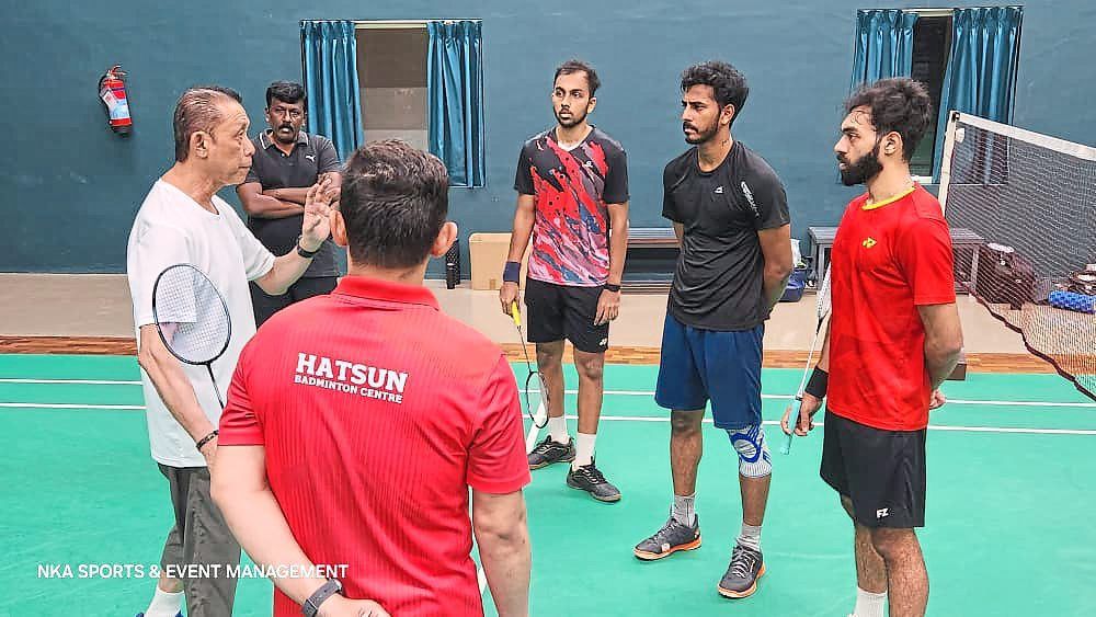 Listen up: Datuk Misbun Sidek stands tall as he gives instructions to the Hatsun Badminton Centre players.
