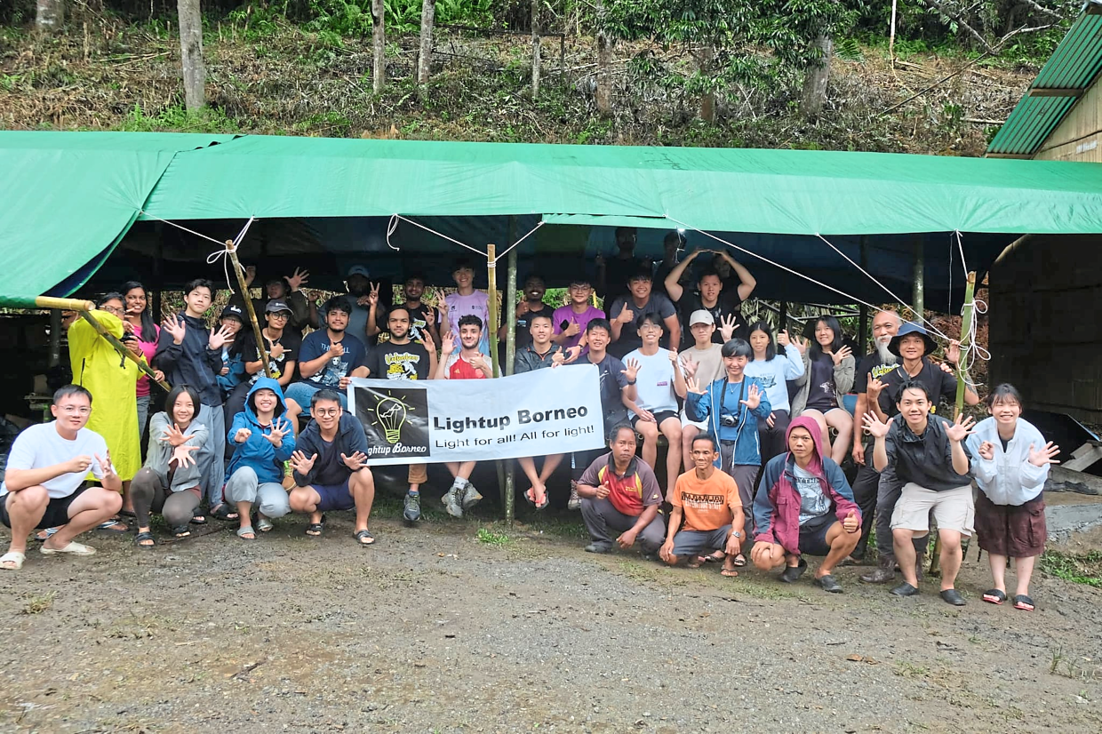 Volunteers celebrating the successful completion of Kampung Ulu Sinderut Hydro Project funded by the Star Social Impact Grant.