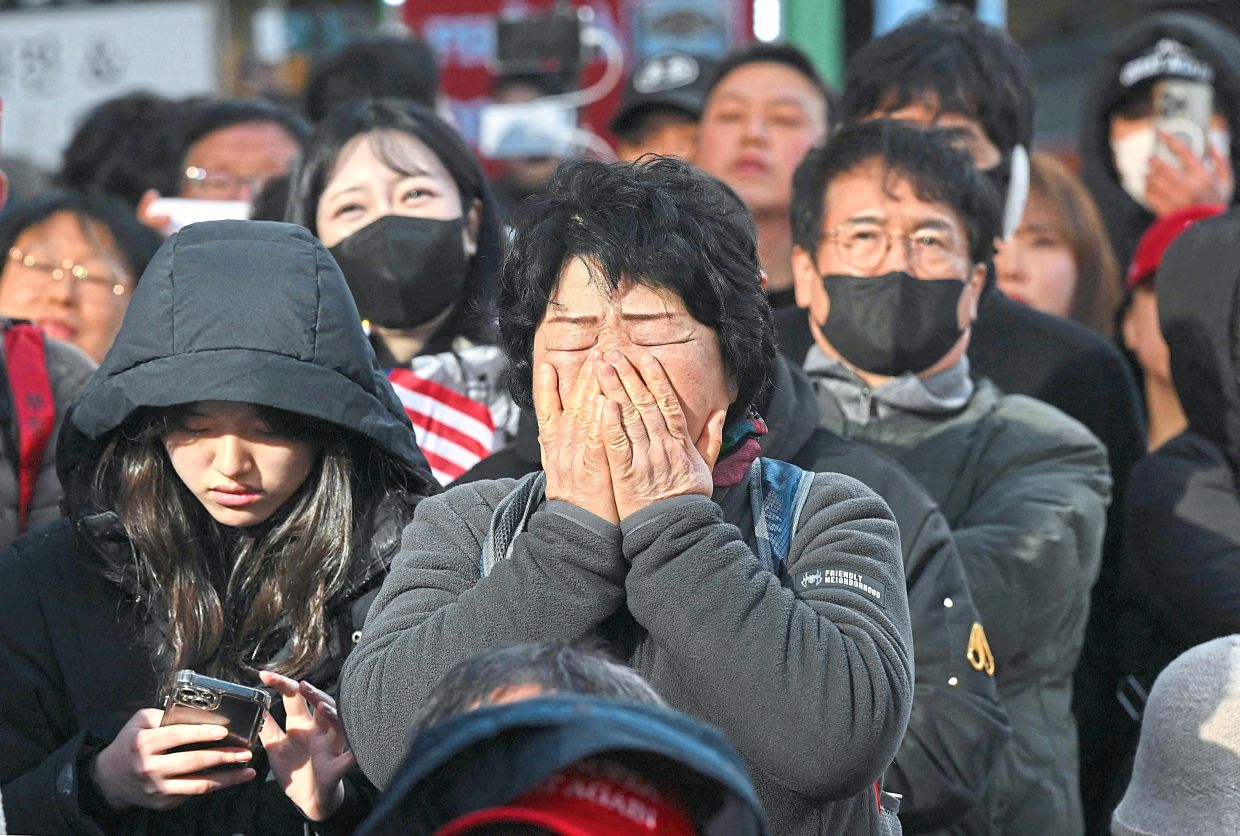 Yoon supporters reacting after the verdict was announced. — AP/AFP 