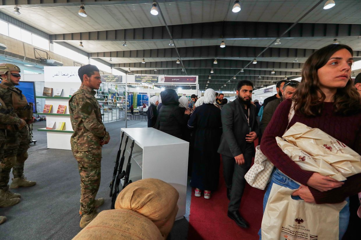 Visitors pass a stand run by the Syrian Defense Ministry at the 57th Damascus International Book Fair on Feb 16, the first since the Assad regime’s collapse. Photo: AP 