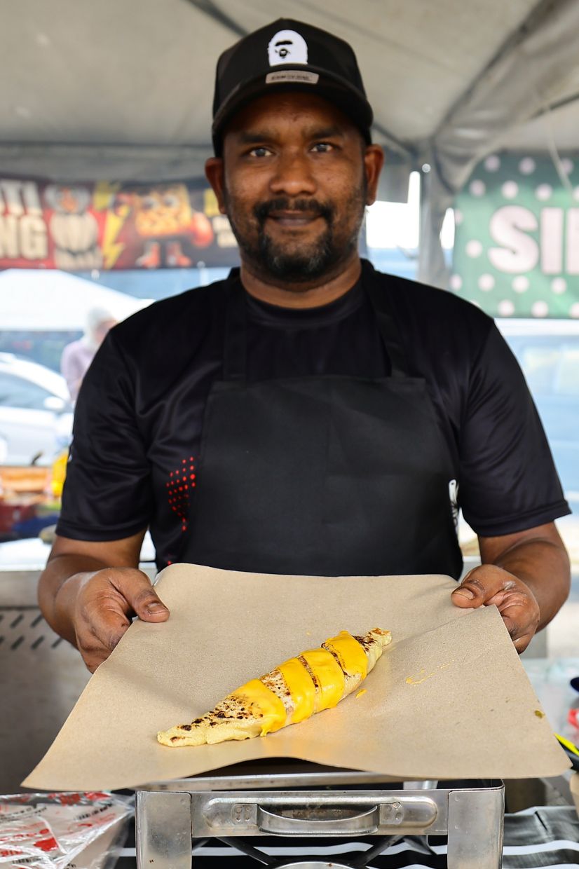 Mohamad Firdaus Kamaruddin, 40, with his roti pocong