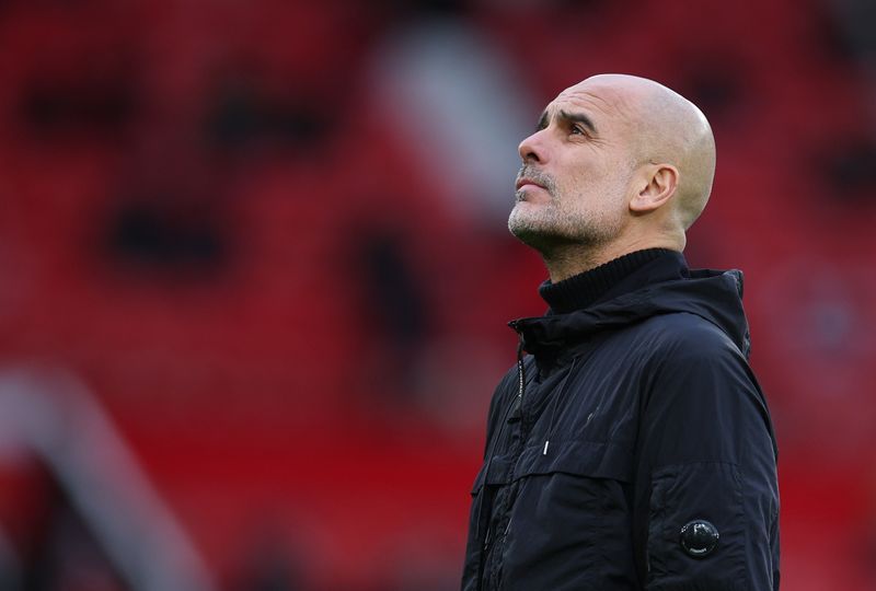 Soccer-City's Guardiola shrugs off tightening title race, saying 12 games is an eternity