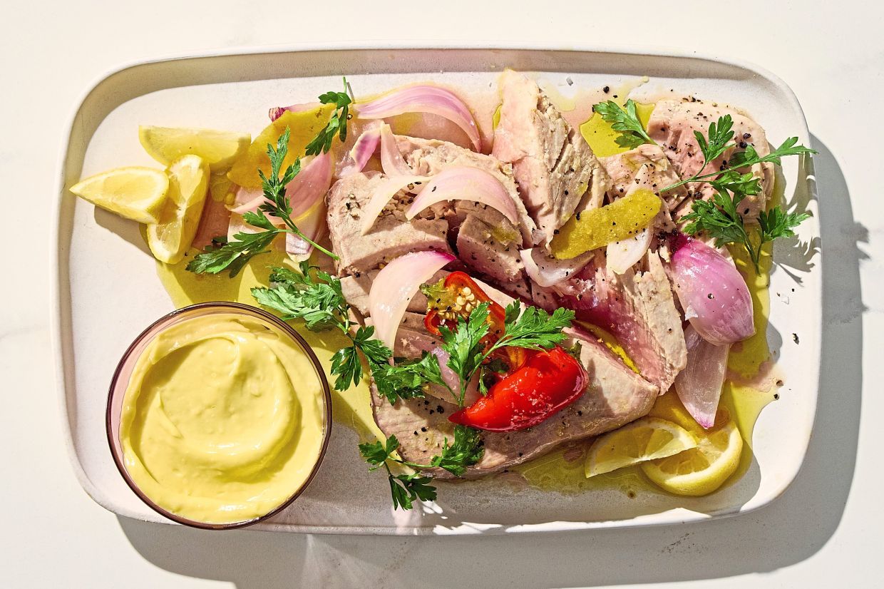 Bathing fish in olive oil makes it deeply flavorful and juicy. — CHRISTOPHER SIMPSON/The New York Times