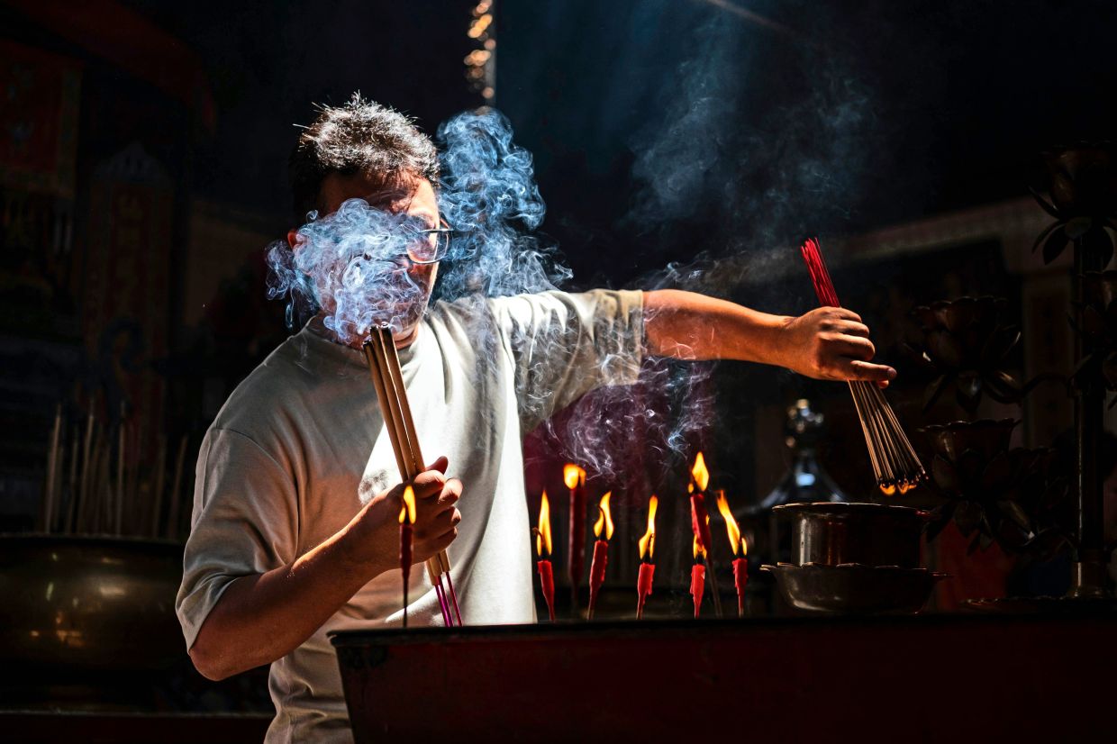 Display of devotion at Sin Sze Si Ya Temple, said to be the oldest Taoist temple in Kuala Lumpur founded in 1864 by Kapitan Yap Ah Loy.