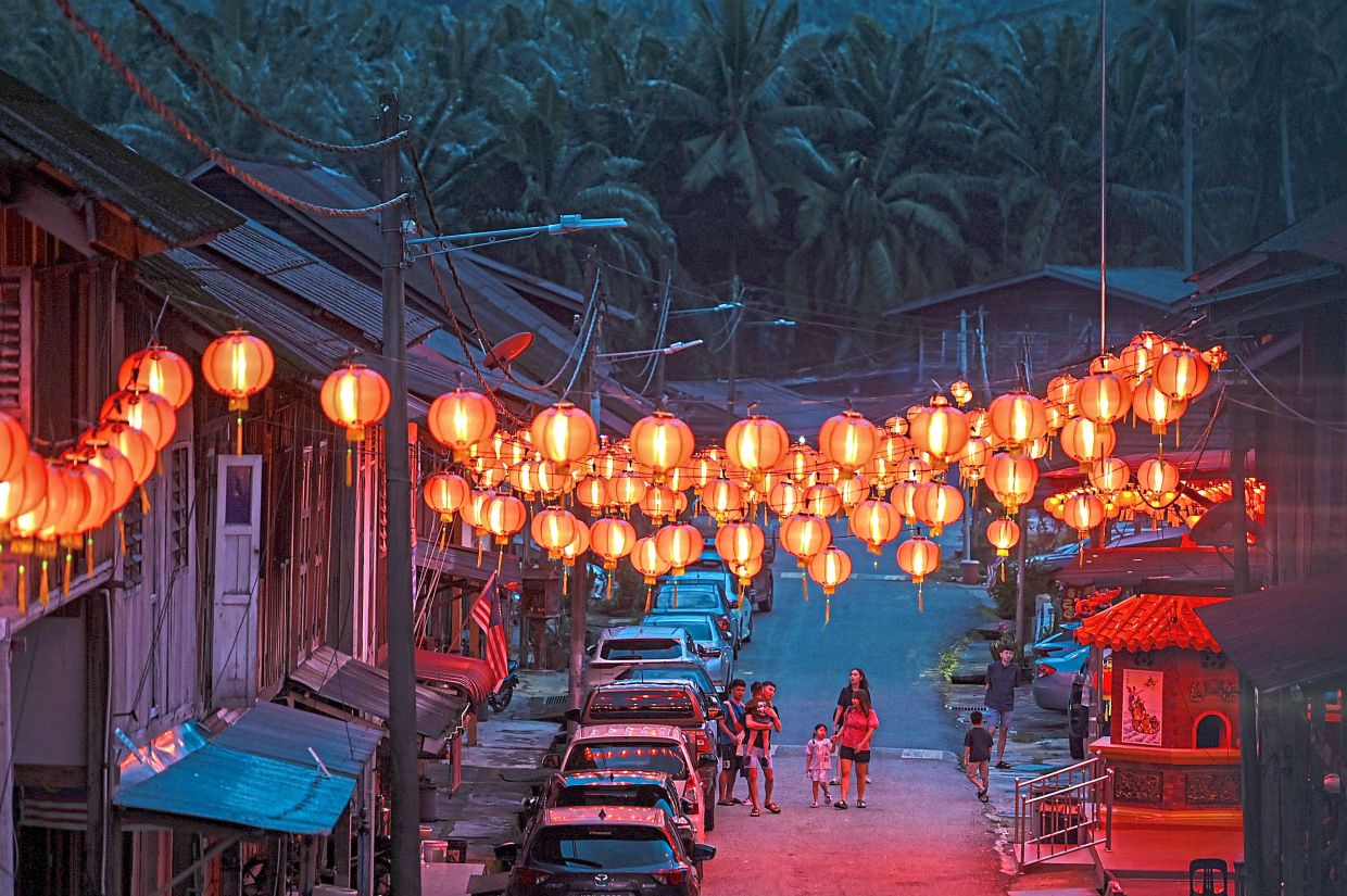 Lanterns cast a warm glow over residents of Kampung Baru Ayer Jerneh, a century-old Hainanese village in Kemaman, Terengganu 