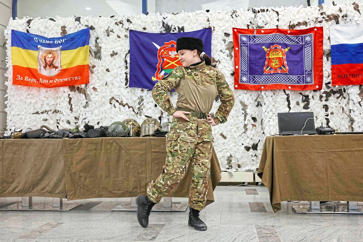 A member of the ‘Berkut Military-Sports Cossack Club’ dancing during the club’s demonstration event at a shopping centre in Voronezh. — AFP