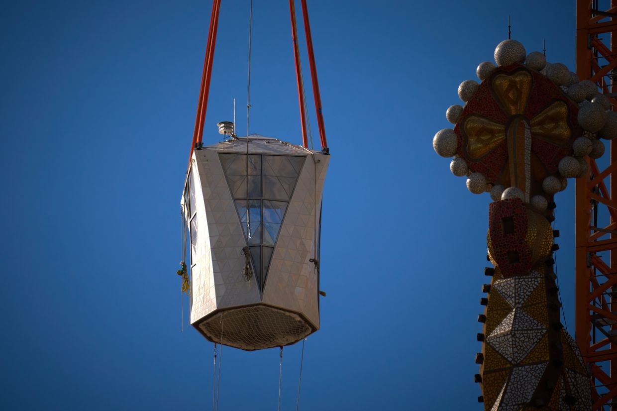 The completion of the 17m-high white cross that stands at the top of the Jesus Christ tower is part of a set of 18 towers originally conceived by Gaudi. Photo: AP