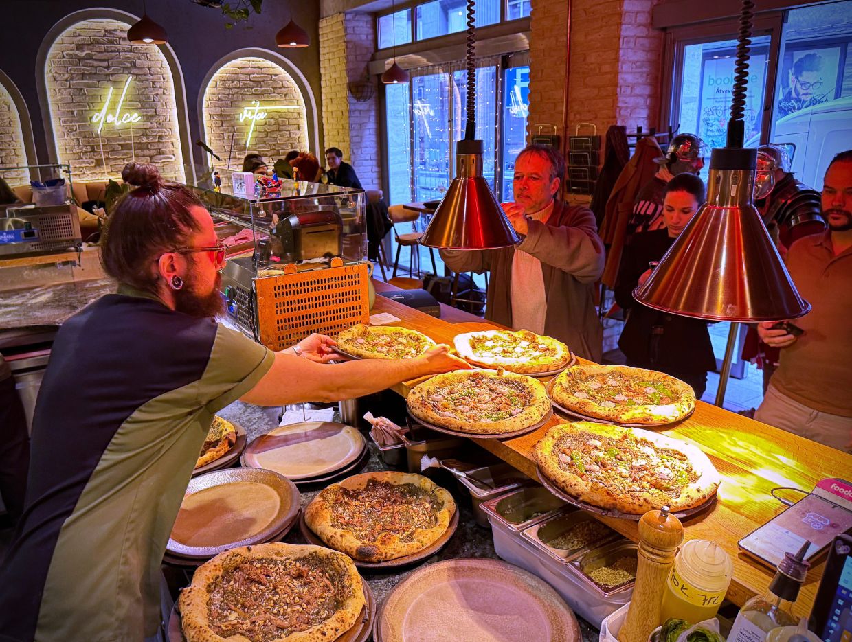 Laszlo Bardossy, head chef of the Neverland Pizzeria serves the restaurant's Roman-era pizza in Budapest, Hungary.