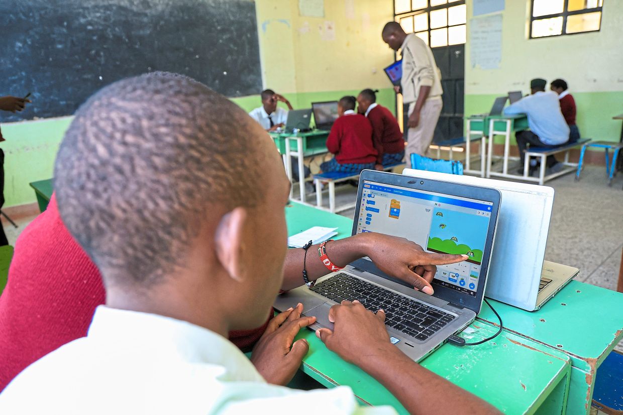 Pupils take part in a computer lesson at Rare Gem Talent School. Photo: AP