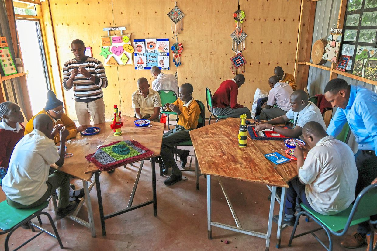 Pupils take part in an arts and crafts lesson. Photo: AP