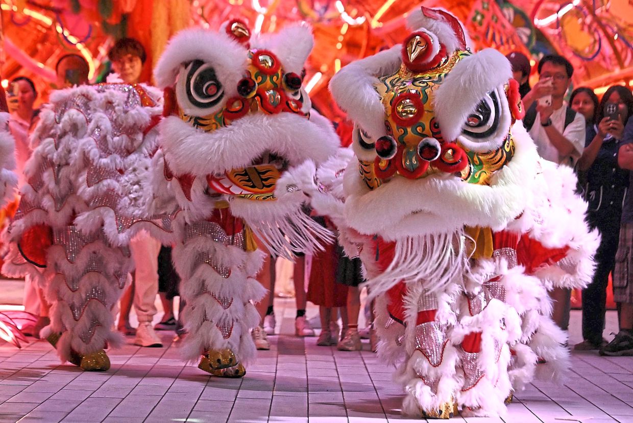 Lion dancers perform outside Emsphere shopping mall on the first day of the Lunar New Year of the Horse, in Bangkok on February 17, 2026. (Photo by Lillian SUWANRUMPHA / AFP)