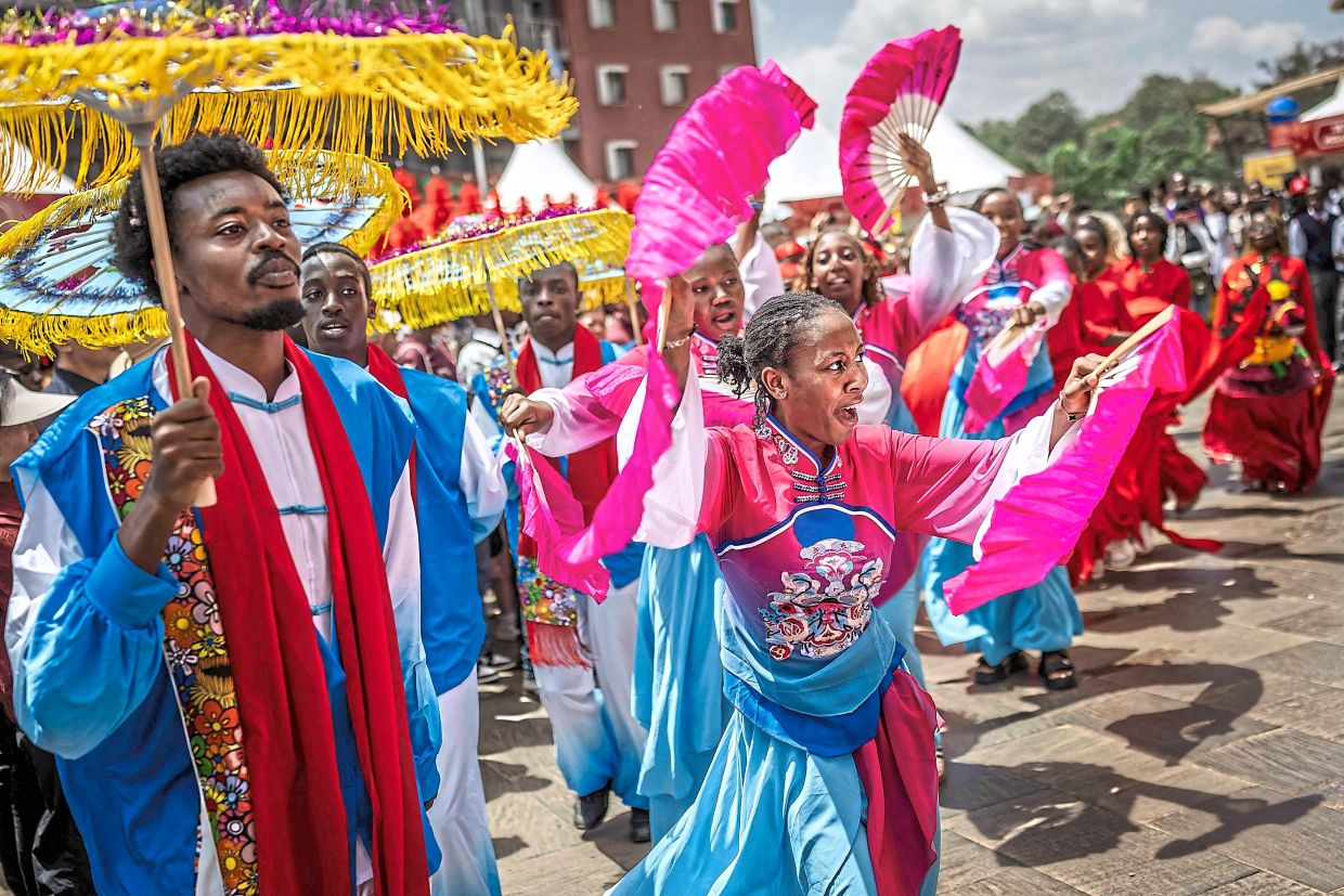 Students from the Confucius Institute take part in a traditional dance performance during celebrations marking the Chinese Lunar New Year in Nairobi, on February 8, 2026, ahead of the upcoming Lunar New Year of the Horse. (Photo by Luis TATO / AFP)