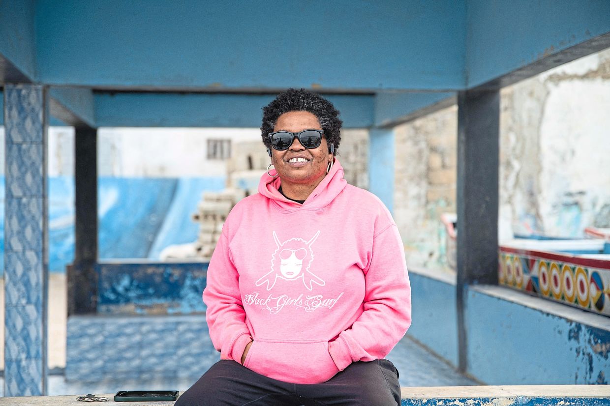 Harper looks on while sitting in the small working-class neighbourhood of Xataxely in Ngor. Harper, who lives between Senegal and California, founded the academy with the aim of teaching surfing to disadvantaged Senegalese girls, many of whom have dropped out of school. — AFP