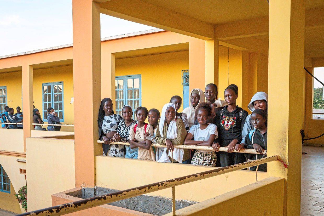 Young participants of the Surf Academy programme posing in the hallways of Stella Maris Primary School in the Ouakam neighbourhood of Dakar. School education and course attendance at all levels are an integral part of Surf Academy. — AFP