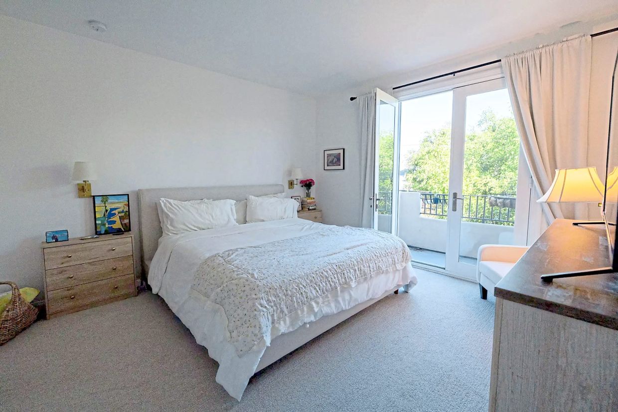 The couple's bed and side tables are among the few new items in their condo.