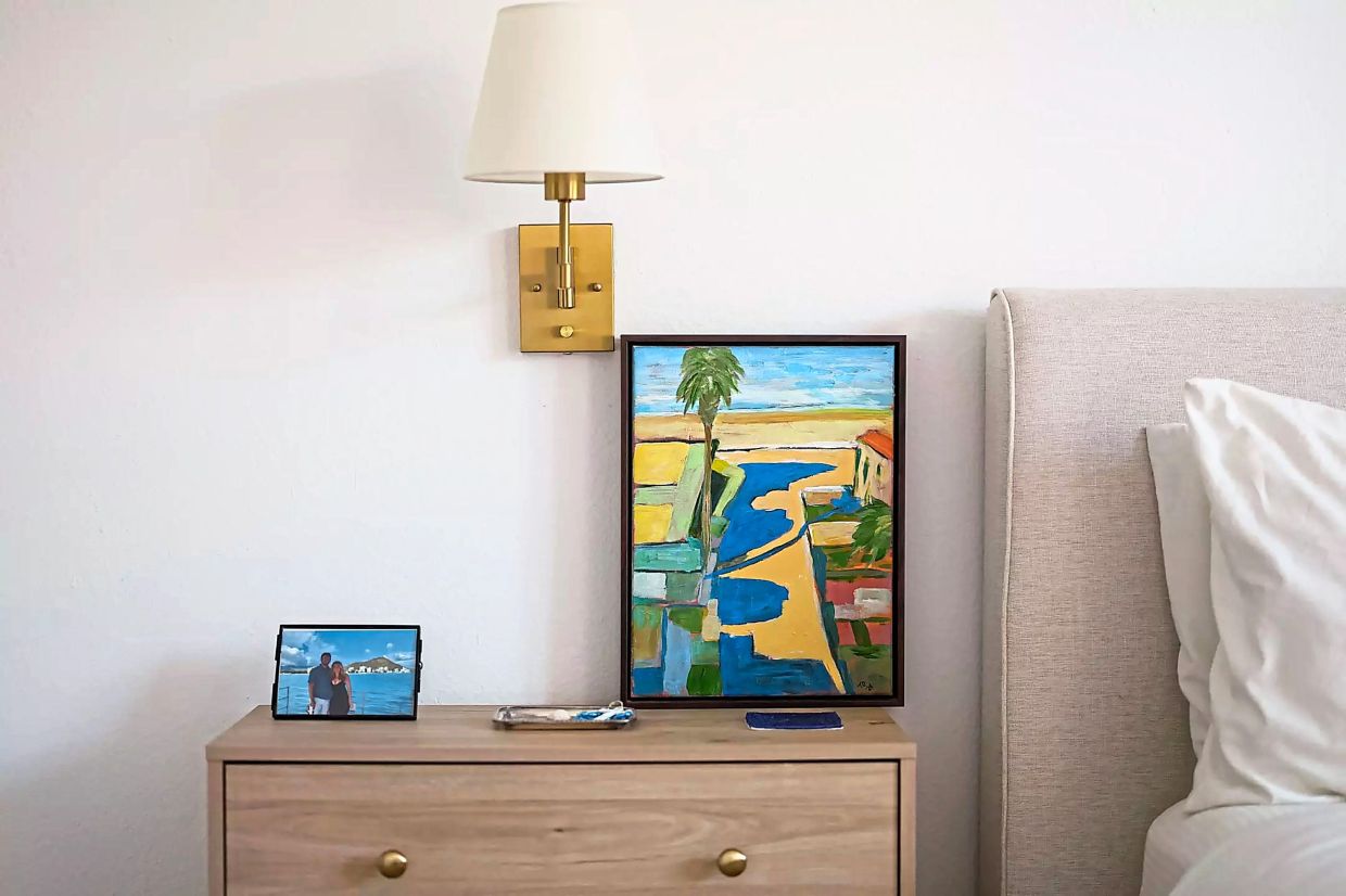 A photograph of the couple rests next to a painting of Manhattan Beach the couple found on social media.