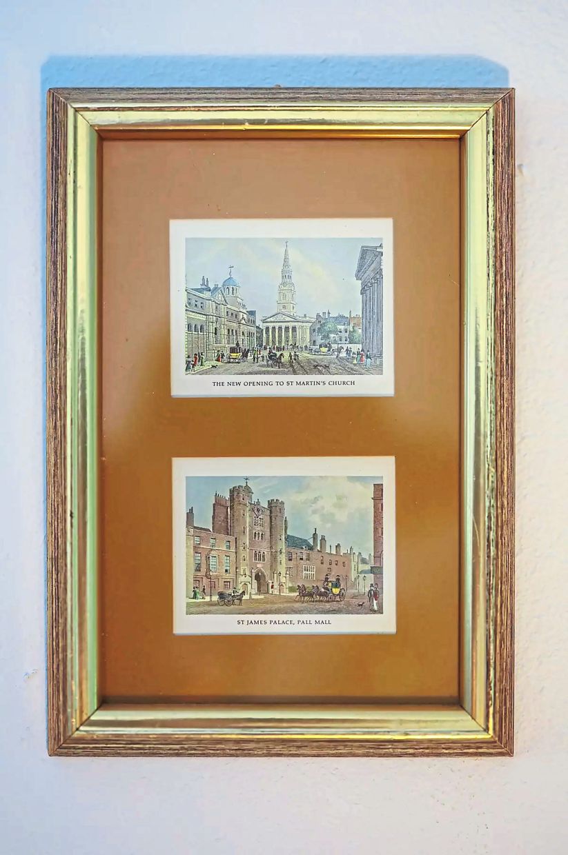 A matted frame with illustrations of St Martin's Church and St James' Palace in London. 