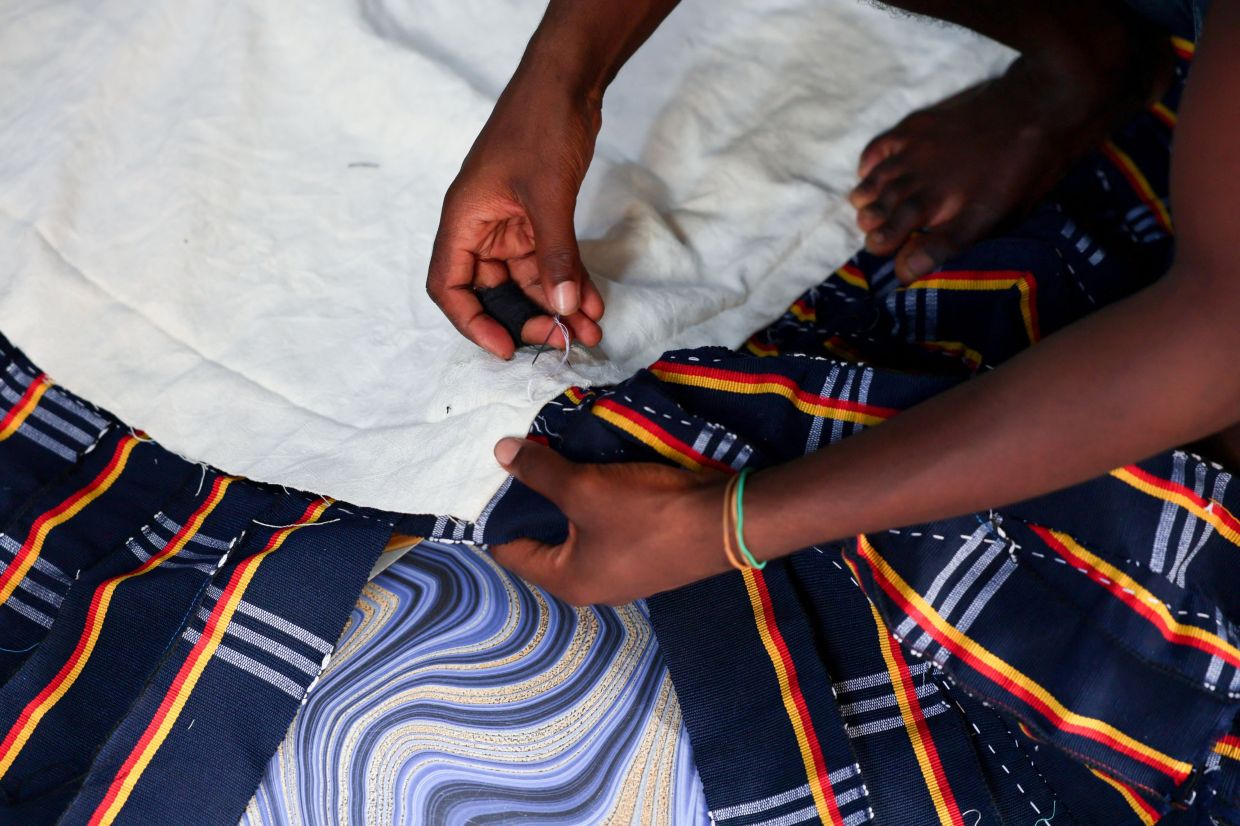 The colourful woven traditional blouse originating from northern Ghana, known as the fugu, smock or batakari, worn by both men and women, is seeing renewed interest after the government declared Wednesdays 'Fugu Day'. Photo: AFP