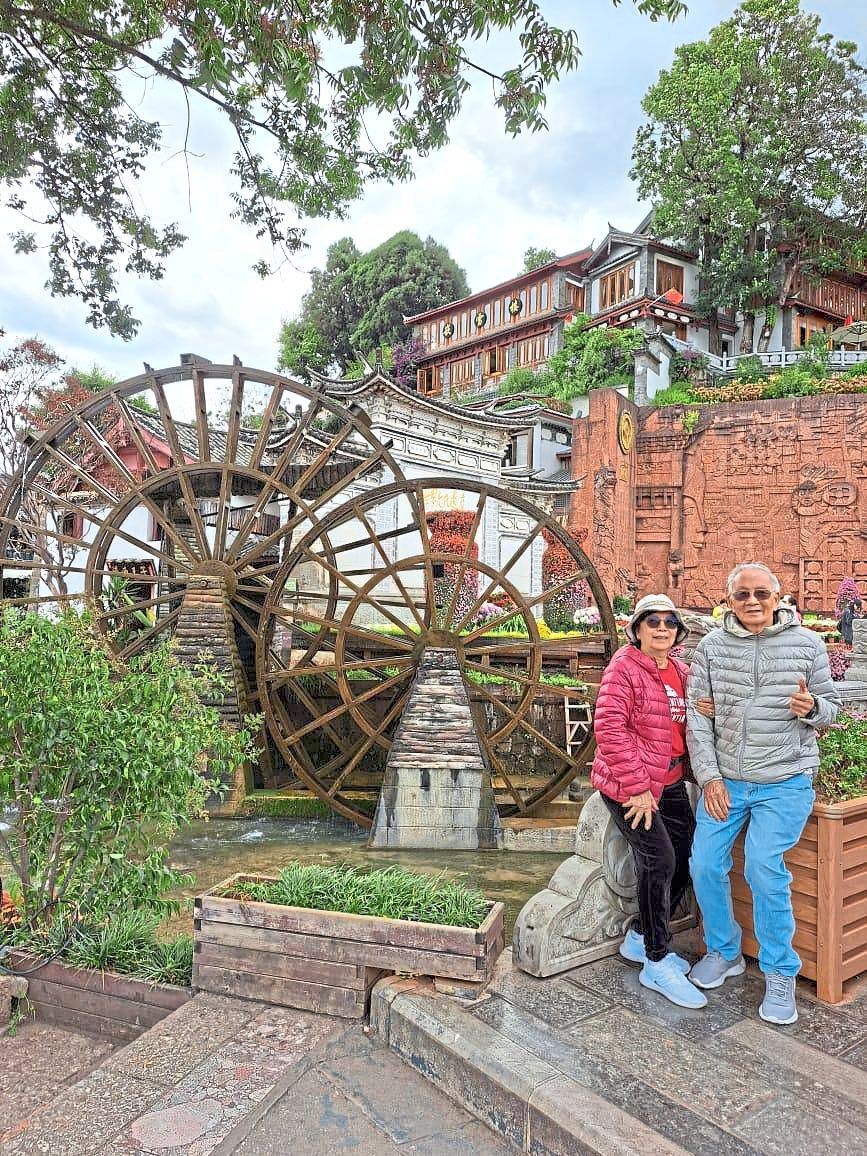 The writer and her husband at Lijiang water wheel.