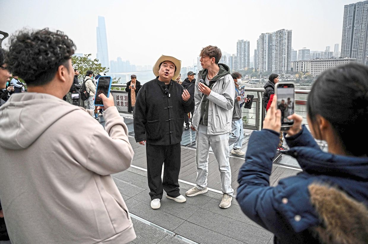 Keeping up appearances: Chen interacting with fans along a street in Chongqing.