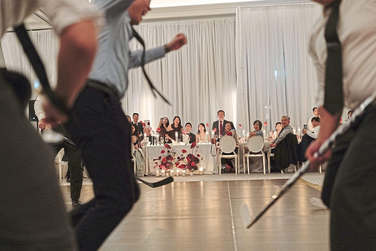 The festivities at the wedding of Huang and Wong included a shootout hockey match, a nod to Wong’s love of hockey. — ALIZA DWORKIND/The New York Times