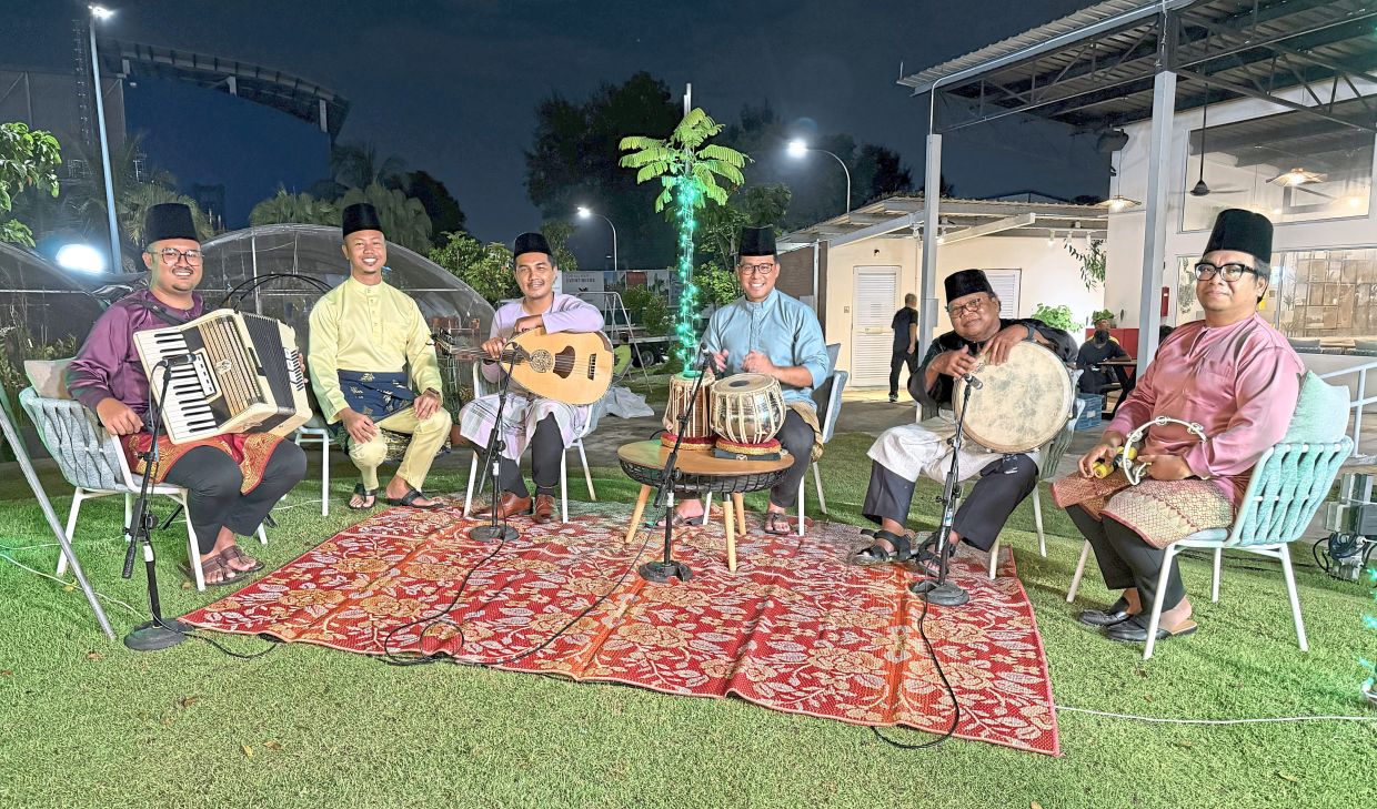 Zaidan (third from left) with his ensemble of Samrah musicians, who perform lively traditional Johor music.