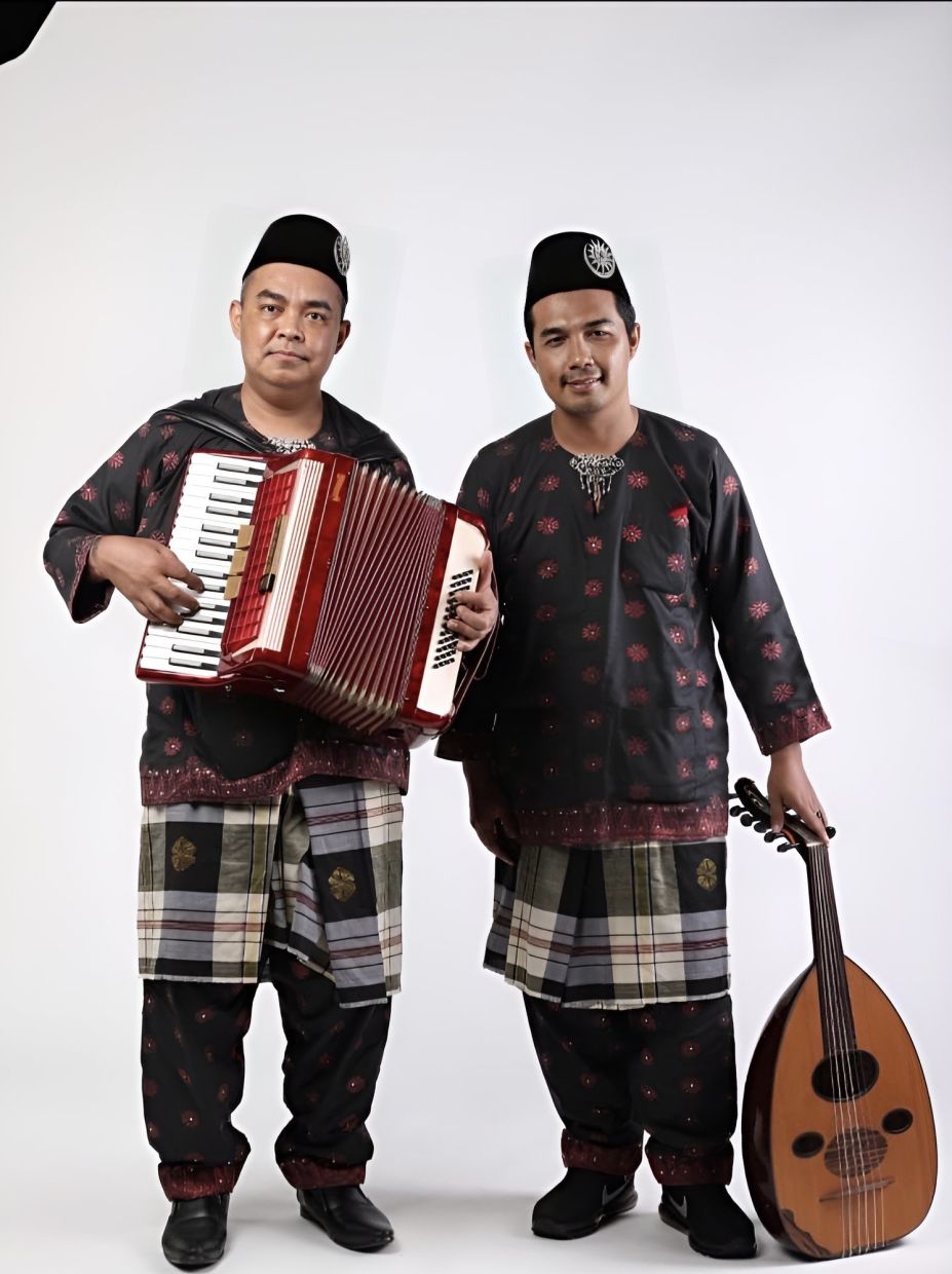Zaidan (right) and his older brother Dr Mohd Nizam are dedicated to keeping the gambus and accordion tradition alive for future generations.